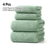 A stack of four light green quilted absorbent towels for bathroom and gym use.