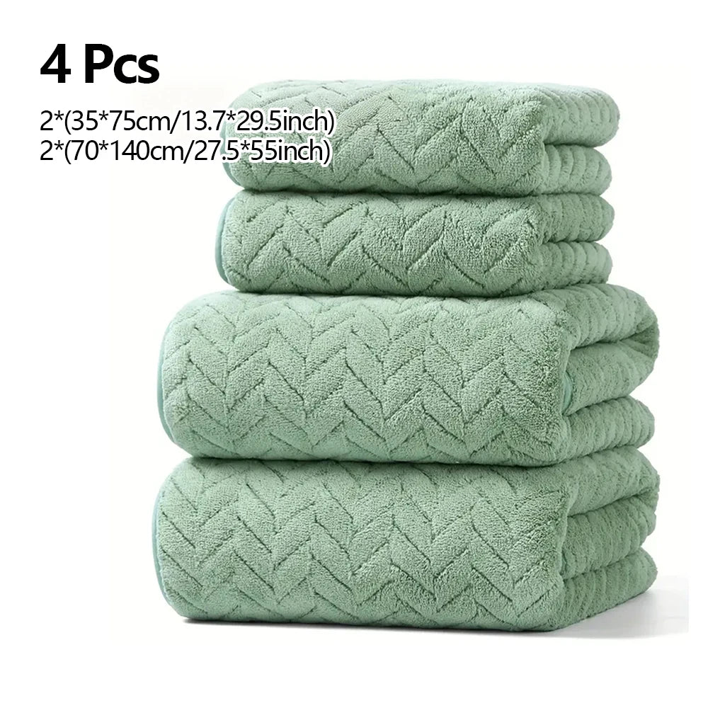 A stack of four light green quilted absorbent towels for bathroom and gym use.