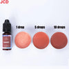 A bottle of Garnet liquid candle dye next to three circular samples showing 1, 5, and 10 drops of the reddish-pink color.
