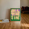 A framed canvas art print with the quote All God Is The Good Time in yellow and purple on a green background
