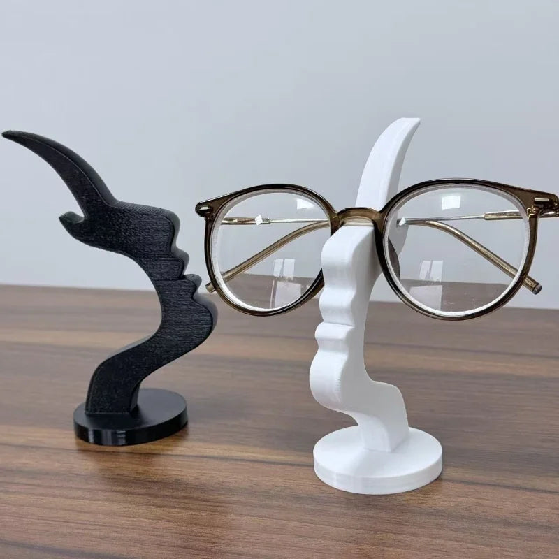 A minimalist 3D printed profile eyeglass stand featuring a black and white design.