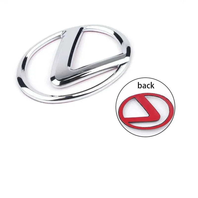Silver steering wheel logo replacement paste with a stylized 'L' design and a red circular back view.