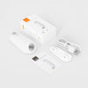 A white motion sensor night light device shown with its packaging and accessories.