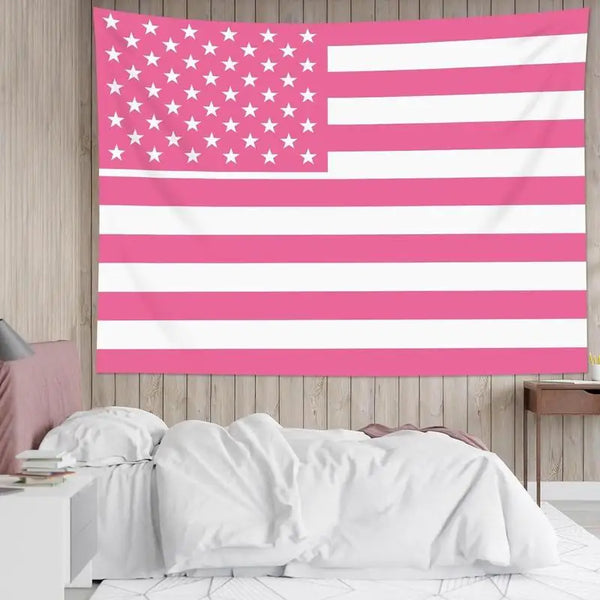 A pink and white striped flag hangs on a wall above a bed.