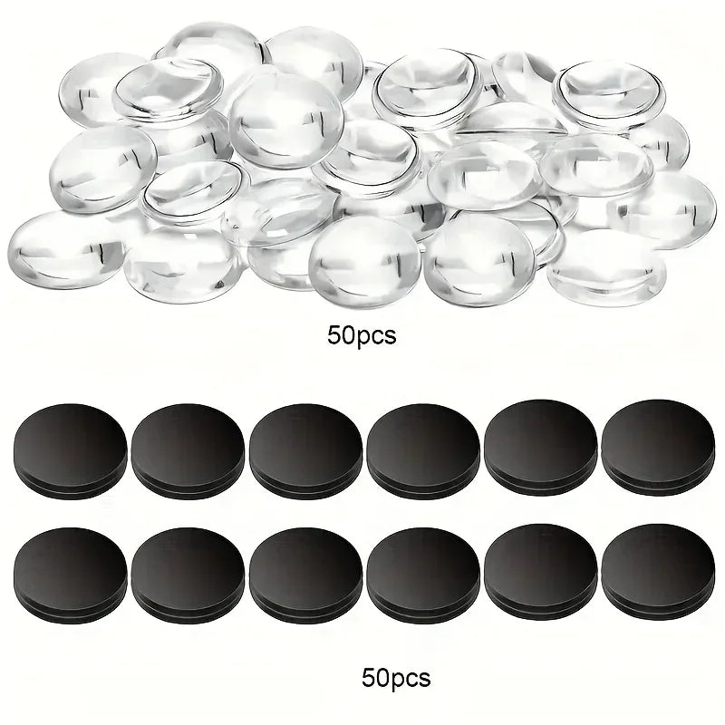 A collection of clear glass refrigerator magnets and black circular magnets are displayed.