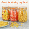 Three glass mason jars filled with dry food, including corn, pickled vegetables, and pasta.