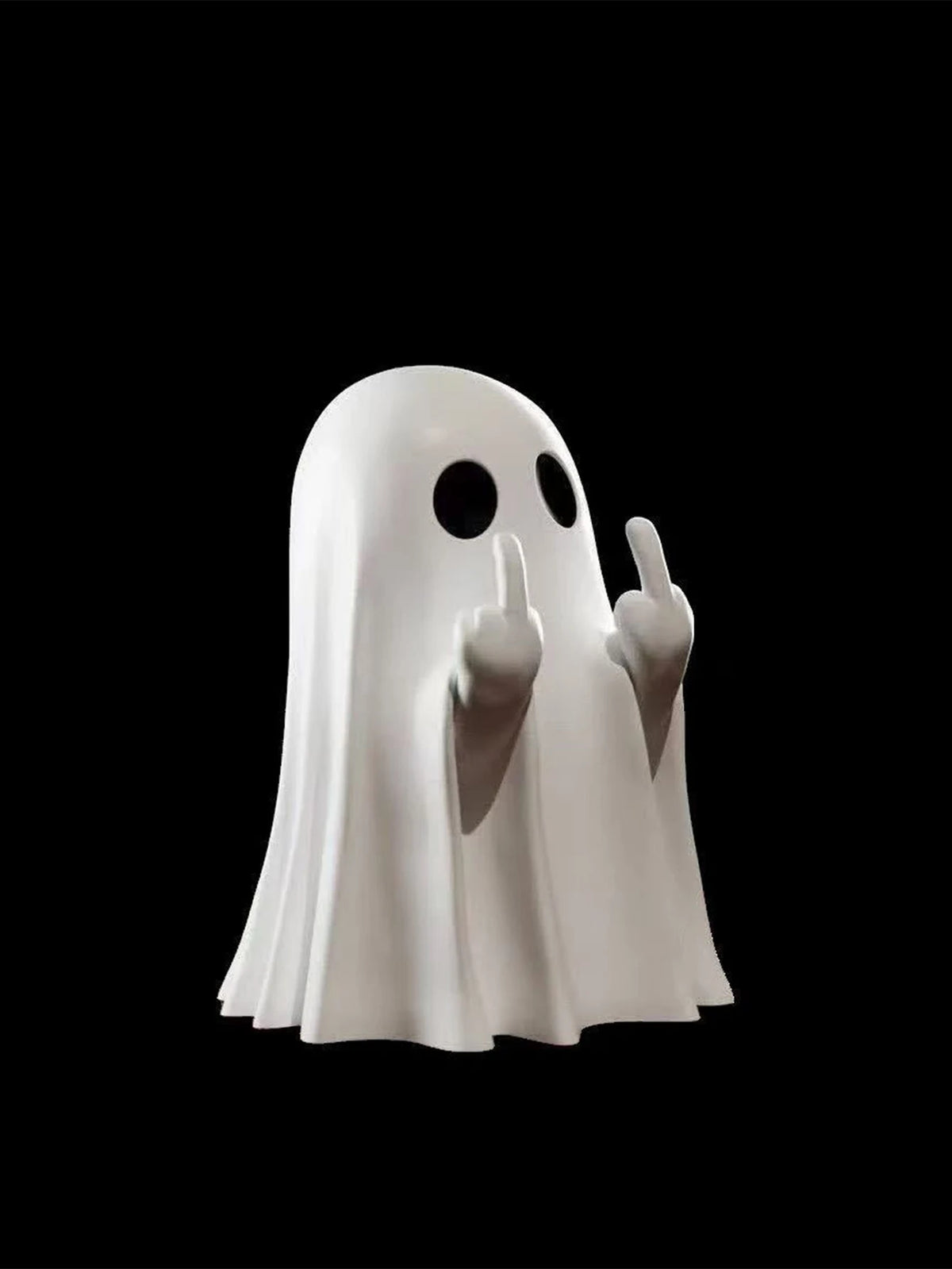 A white ghost statue decoration with raised index fingers against a black background.