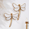 Golden dragonfly mirror wall decor featuring a detailed, gilded insect design.