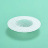 A white kitchen sink drain strainer and hair catcher with a perforated mesh design.