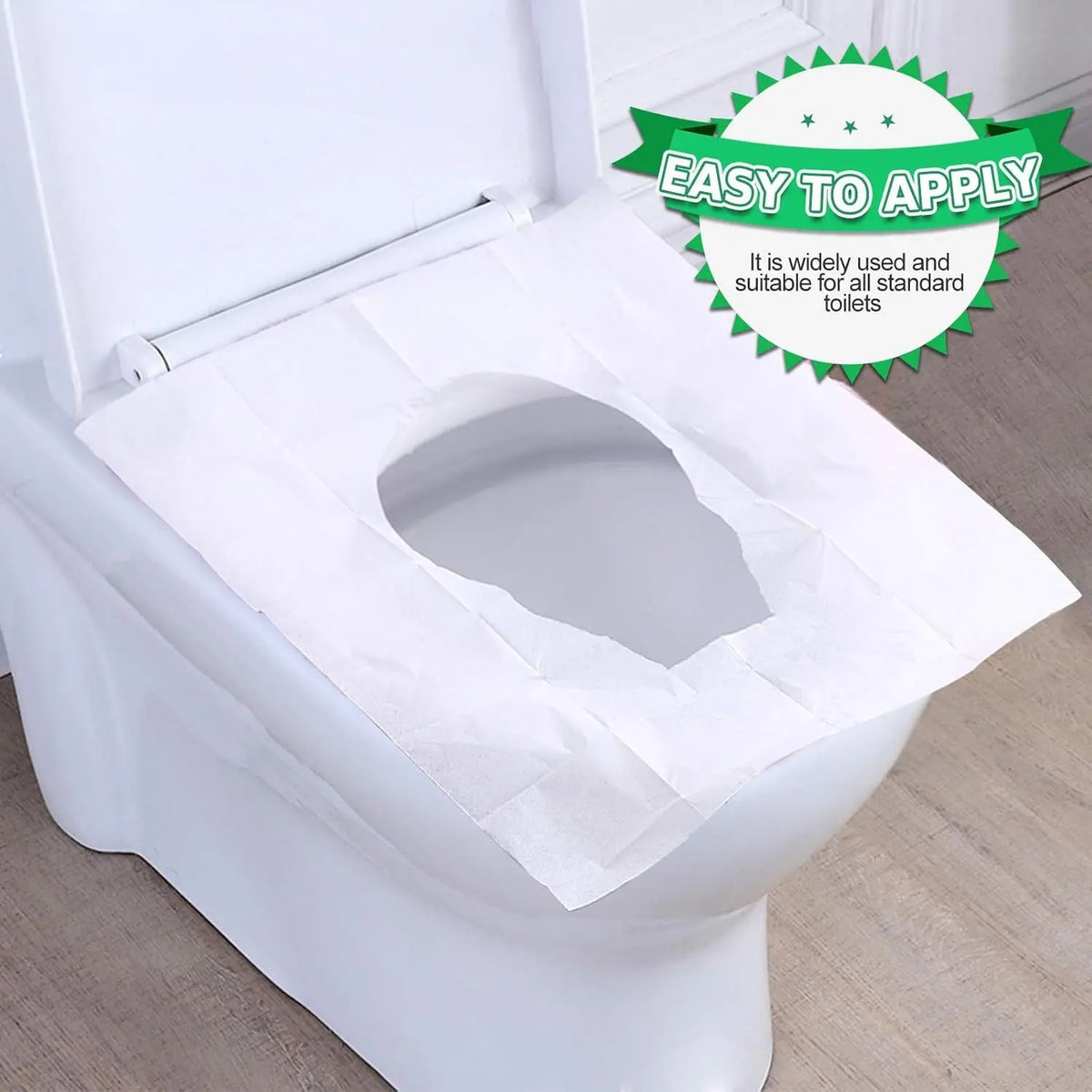 A white disposable toilet seat cover is shown placed inside a white toilet bowl.