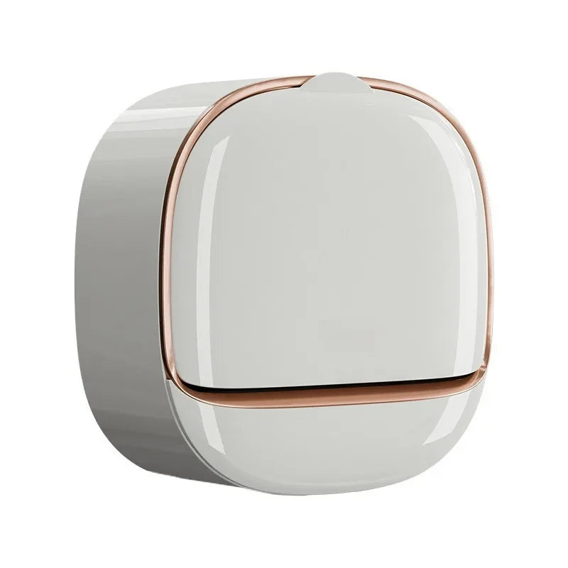 A wall-mounted soap dish with a lid and drainage, featuring a smooth, light gray body and rose gold accents.