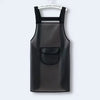 A black waterproof transparent kitchen apron hanging on a hanger.