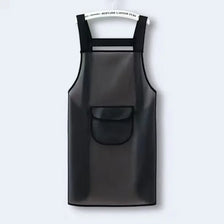 A black waterproof transparent kitchen apron hanging on a hanger.