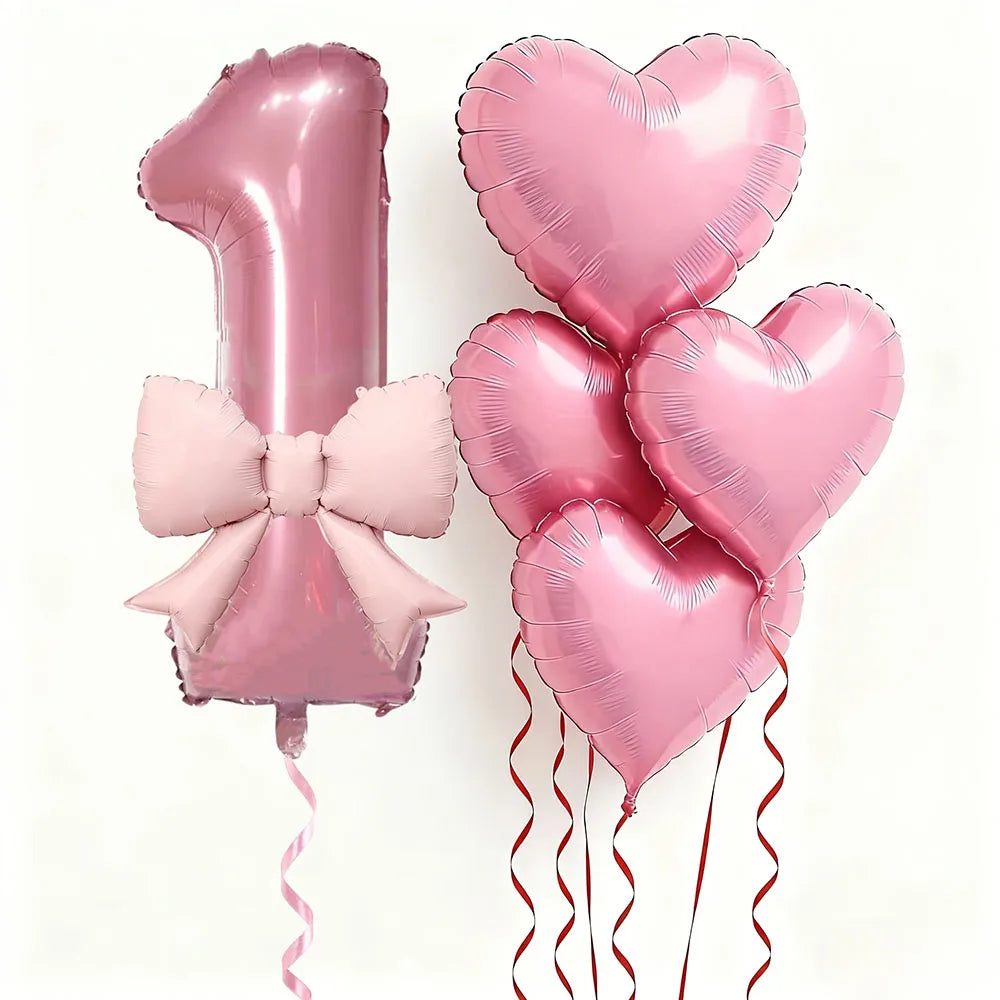 Un juego de seis globos de látex en forma de corazón rosa, incluyendo el número uno, para una celebración.
