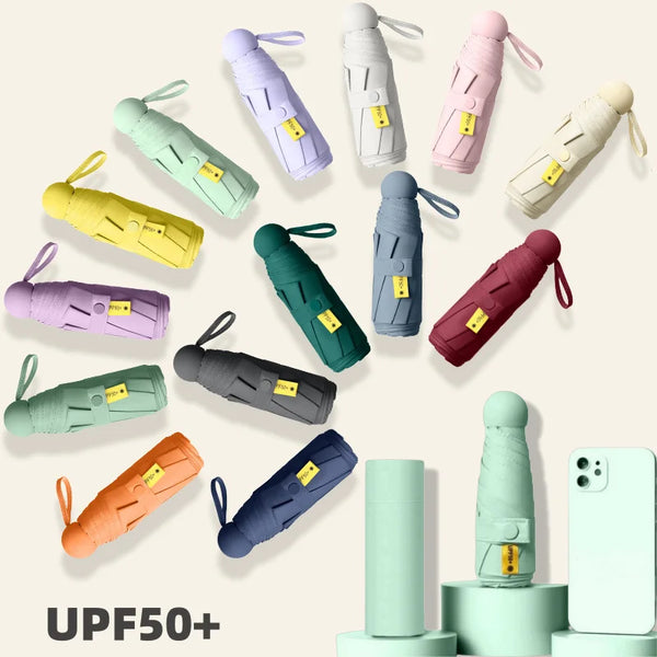 A collection of various colored folding UV protection umbrellas displayed against a light background.