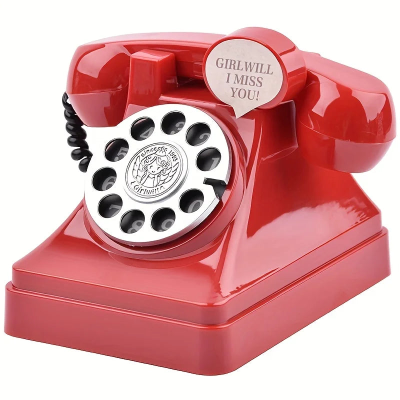 A red retro telephone shaped like a money jar with a cutout saying Girlwill I Miss You!