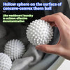 A hand holds a white silicone laundry ball on the surface of a concave-convex thorn ball.