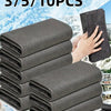 A stack of dark gray reusable microfiber cleaning cloths is shown against a snowy outdoor background.