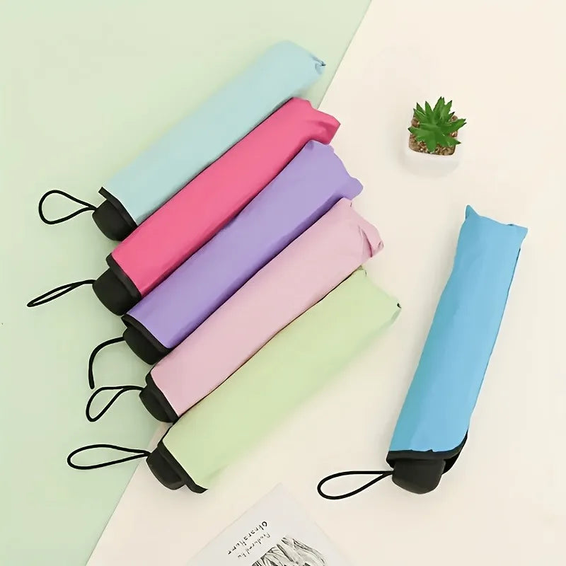 A set of reversible umbrellas in various pastel colors including pink, purple, and light blue, displayed on a white surface.