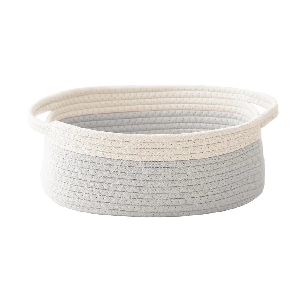 Light gray handwoven rope storage basket with handles