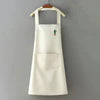 A classic black chef apron with a large front pocket hanging on a hanger.