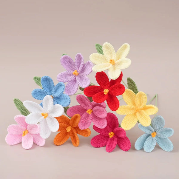 A bouquet of handmade crochet tulip flowers in various shades of pink, yellow, and blue.