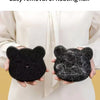 A person is demonstrating the easy removal of floating hair using a black cat-shaped pet hair remover sponge.