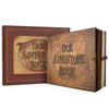 A brown leather photo album with a textured cover featuring the words Our Adventure Book stamped on a globe design.