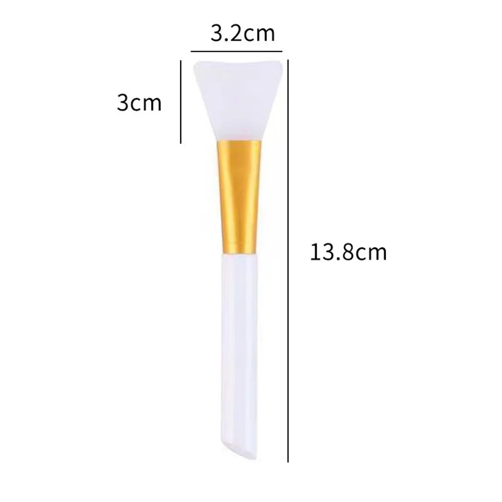 A white silicone facial mask brush with a gold handle shown next to dimension lines.