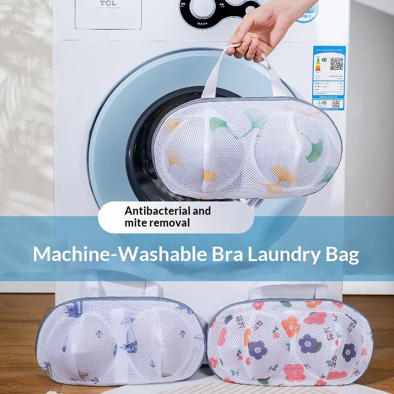 A white washing machine drum holds a mesh laundry bag for bra and lingerie protection.