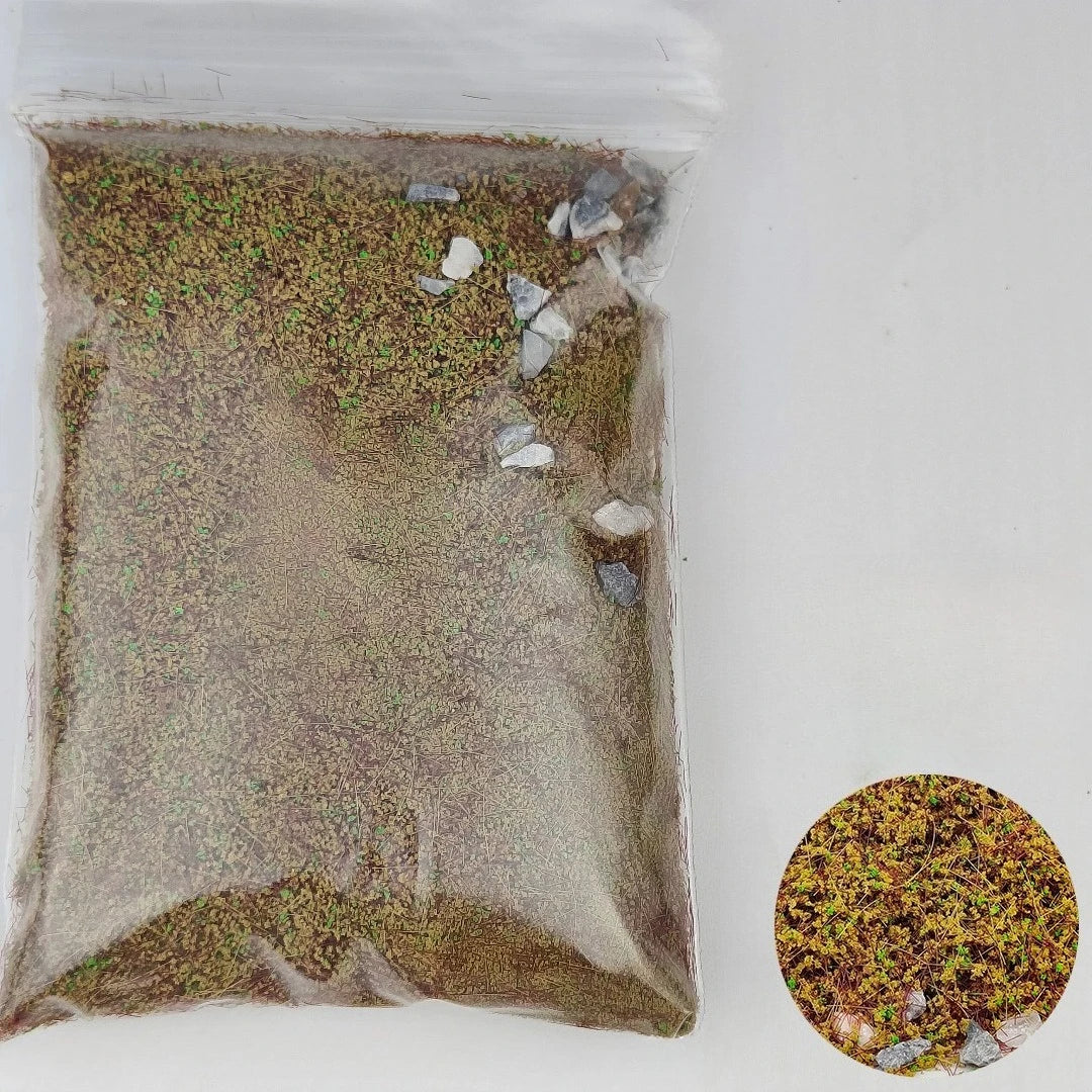 A clear plastic bag filled with a DIY miniature landscape kit containing simulated grass and small stones.