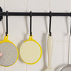 A set of yellow and white reusable double-sided dishwashing sponges hanging on a black bar.