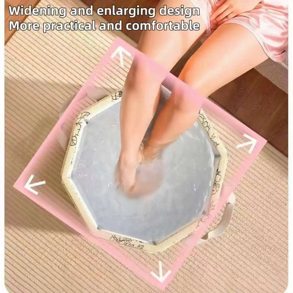 A person's legs and feet are shown soaking in a pink foldable foot bath tub for soothing relief.
