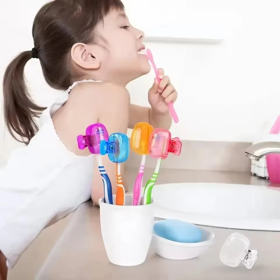 A young girl is using pink reusable toothbrush head covers on an electric toothbrush.
