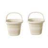 A pair of light beige collapsible water buckets with handles shown side by side.