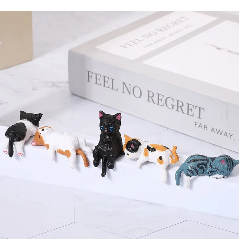 A set of cute healing cat figurines featuring various black, white, and orange patterned cats displayed on a white surface.