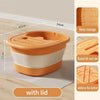 An orange and white portable foot bath tub with a lid shown on a wooden floor.