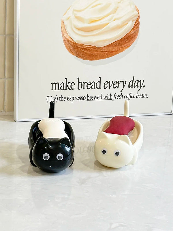 A cute cat-shaped soap dish with a drainage rack for the bathroom, featuring white and black ceramic designs.