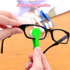 A hand is holding a green cleaning tool for an eyeglasses frame, demonstrating the use of an ABS material cleaning kit.