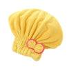 A yellow microfiber hair drying towel cap with a gathered, fluffy texture.