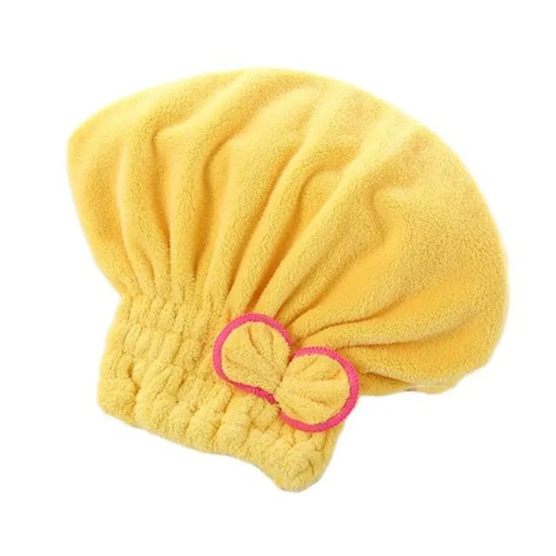 A yellow microfiber hair drying towel cap with a gathered, fluffy texture.