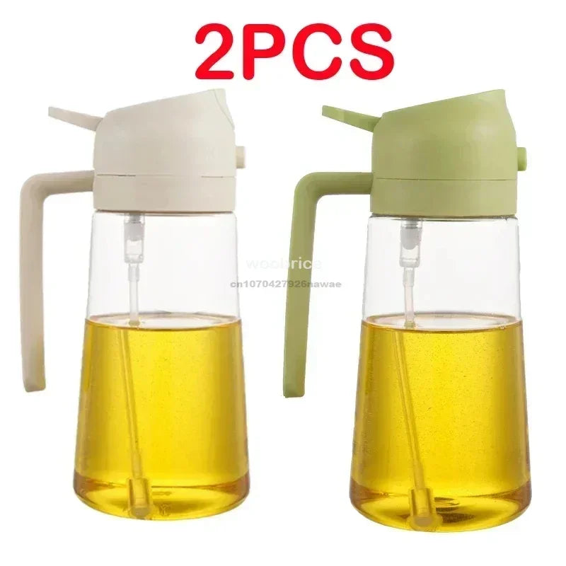 Two clear glass oil spray bottles with white and green tops, filled with yellow cooking oil.