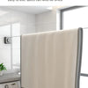A beige retractable wire clothesline is shown hanging in a modern bathroom or laundry area.