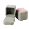 A light gray velvet jewelry box with a hinged lid, showing a pink velvet insert.