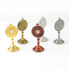 A collection of mini metal religious ornaments featuring sunburst designs in gold, silver, and copper tones.