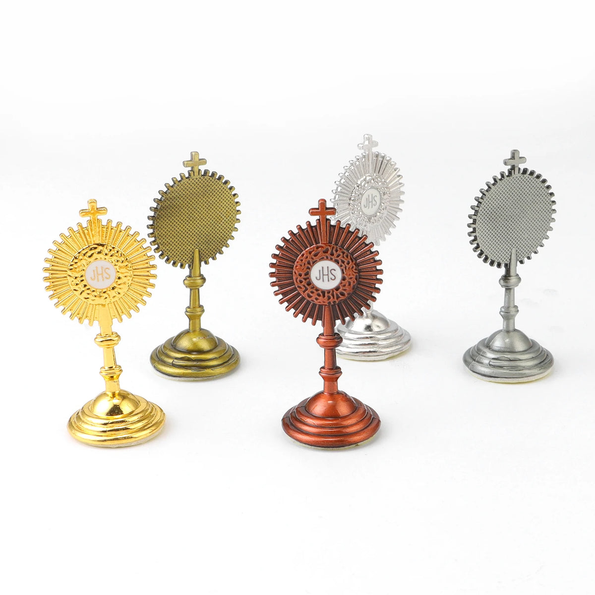 A collection of mini metal religious ornaments featuring sunburst designs in gold, silver, and copper tones.