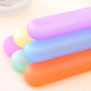 A row of colorful, cylindrical portable toothbrush storage cases in shades of purple, yellow, blue, and orange.