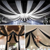 Elegant black sheer chiffon fabric draping creating a flowing ceiling canopy for an event.