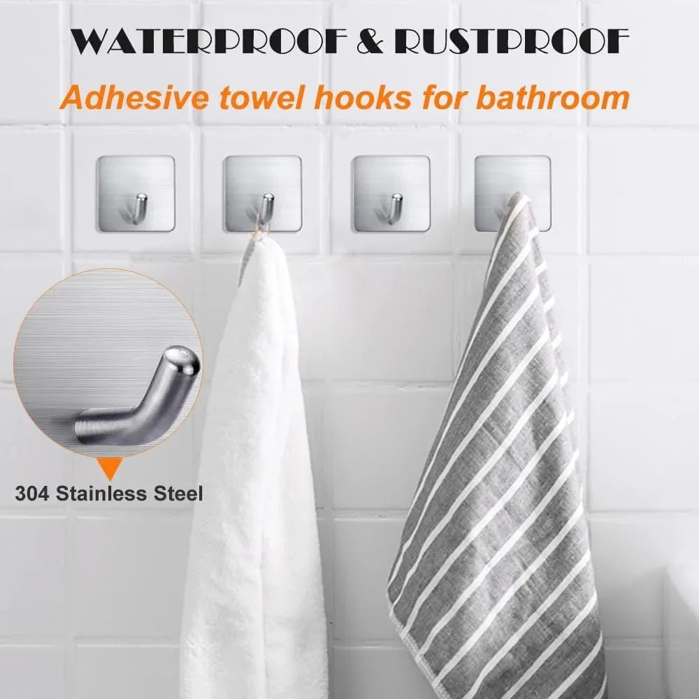 Adhesive towel hooks made of stainless steel mounted on a white tile wall.