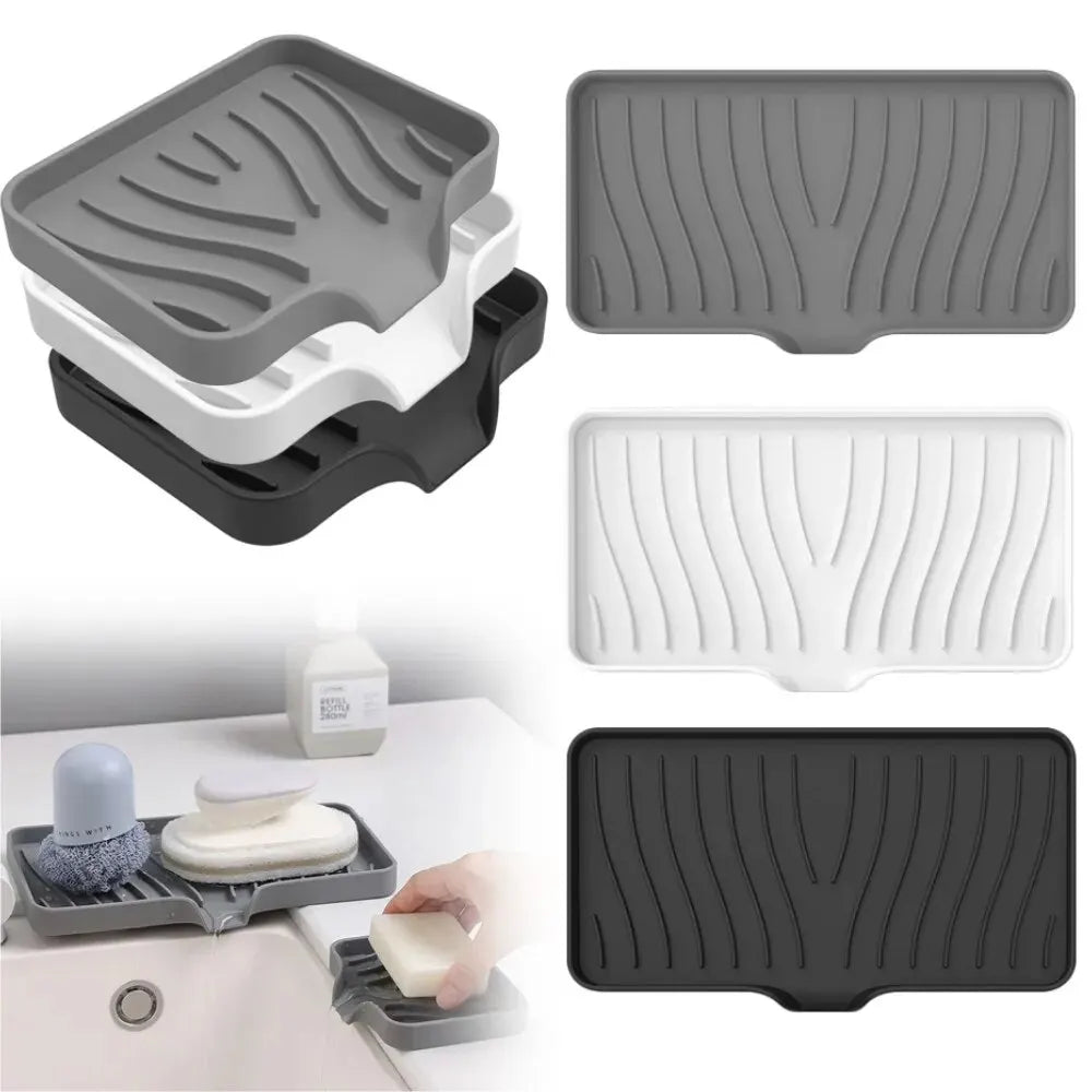 A set of silicone draining soap tray organizers in gray, white, and black are shown with a hand placing a white soap bar on o